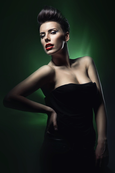 sexy brunette woman with red lips in dark green light - Фото, изображение