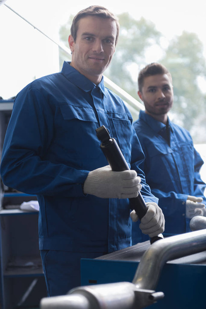 Positive car mechanic holding tool - Photo, Image