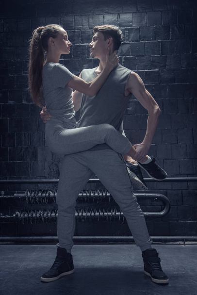 Young dancers performing in close interaction with each other - Foto, Imagem