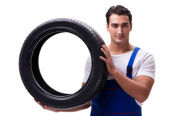 Handsome tyre repairman isolated on white - Photo, image