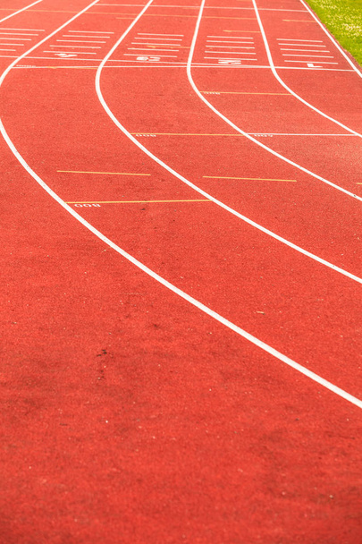 Red running track in stadium. - Φωτογραφία, εικόνα