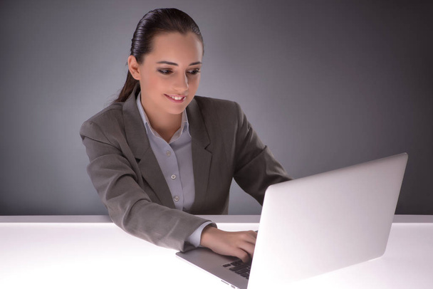 Young businesswoman working with laptop in business concept - Photo, Image