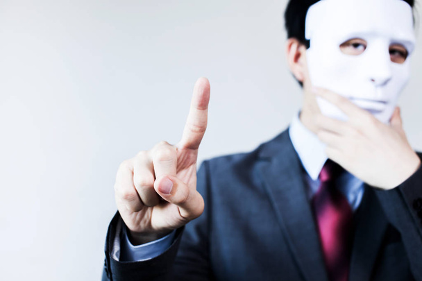 Anonymous businessman in mask hiding himself touching on virtual screen - with copyspace. - Fotoğraf, Görsel