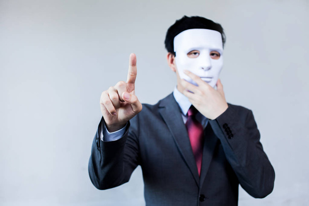 Anonymous businessman in mask hiding himself touching on virtual screen - with copyspace. - Φωτογραφία, εικόνα