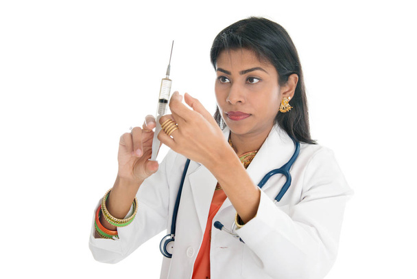 Indian female doctor with syringe - Foto, afbeelding
