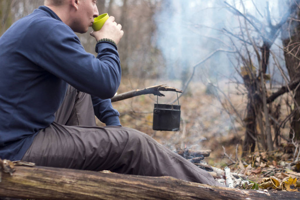 Travelling around the campfire with a tent drinking tea - Photo, Image