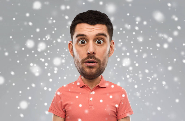 surprised man in polo t-shirt over snow background - Фото, изображение