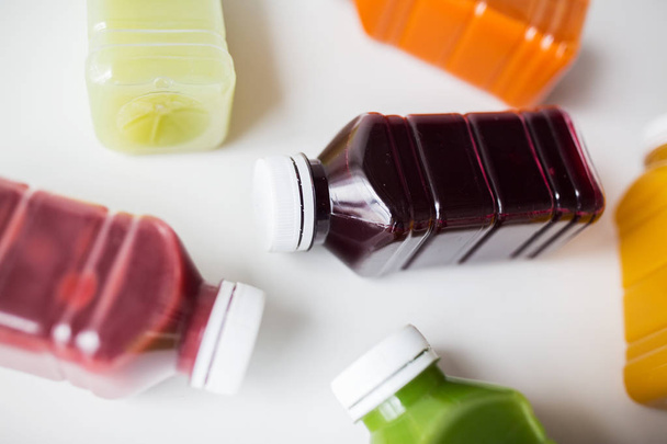 bottles of different fruit or vegetable juices - Zdjęcie, obraz