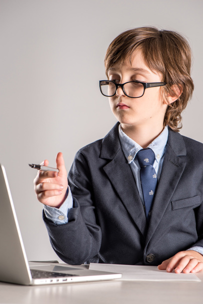 Schoolchild in business suit with pen in hands - Foto, Imagem