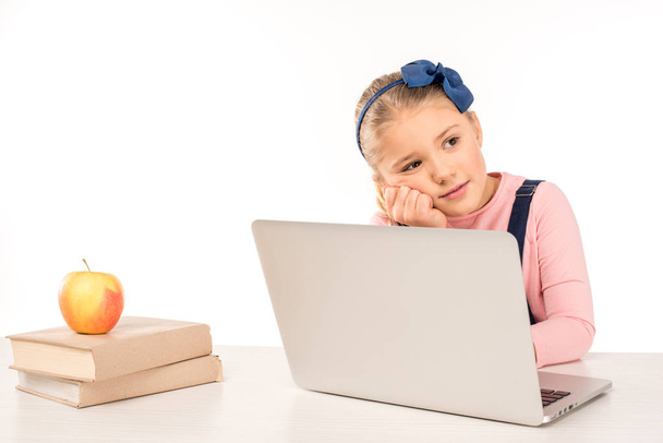 Schoolgirl at desk with laptop - Fotoğraf, Görsel