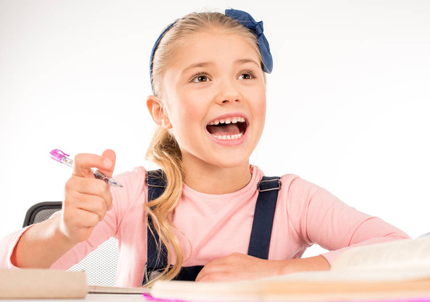 Excited schoolgirl studying on lesson  - Foto, imagen