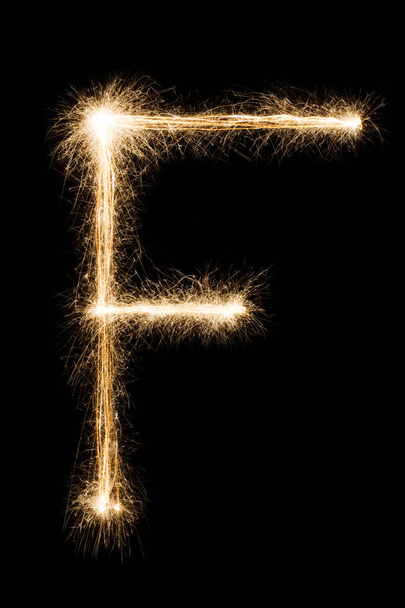 English Letter F from sparklers alphabet on black background. - Фото, зображення
