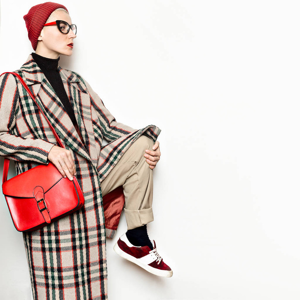 Young hipster girl student style trendy checkered coat and beani - Фото, зображення