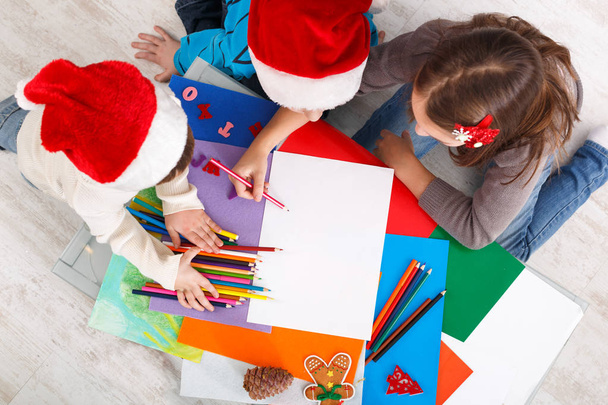 Children writing letter to santa, wait for christmas, top view - 写真・画像