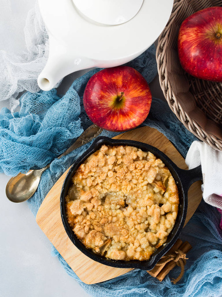 Home made apple crumble in cast iron skillet. Vertical - Photo, Image