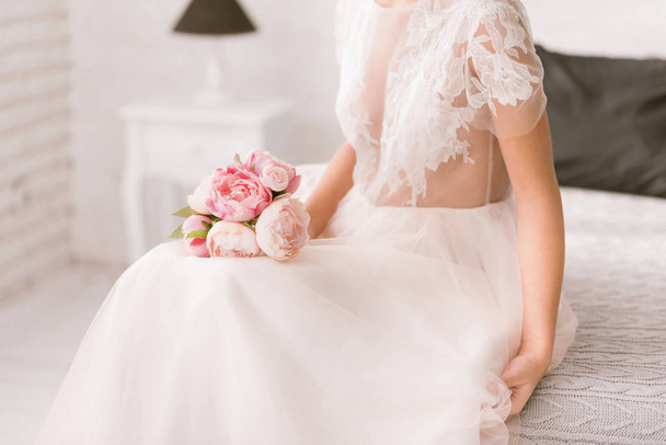 Pleasant bride holding the wedding bouquet - Фото, зображення