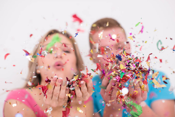 young romantic  couple in love  celebrating and blowing confetti decorations - Fotó, kép