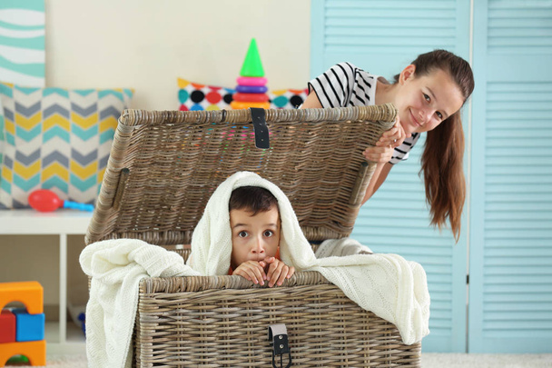 Brother and sister playing with wicker box - Φωτογραφία, εικόνα