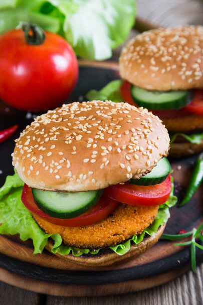 Fishburger with vegetables on a bun with sesame seeds - Photo, Image