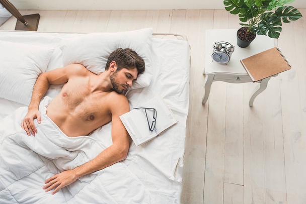 Handsome male is napping in bedroom - Foto, Bild