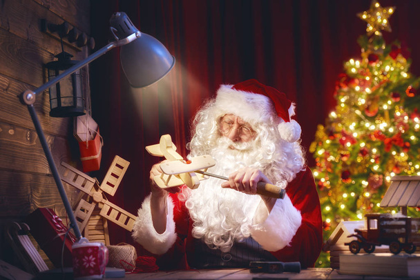 Santa Claus is preparing gifts - Фото, изображение
