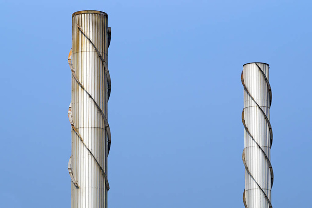 дымоход из нержавеющей стали на фоне голубого неба
 - Фото, изображение
