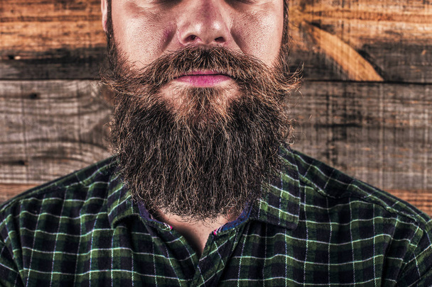 Closeup of a man beard and mustache over wooden background.Perfect beard - Fotografie, Obrázek