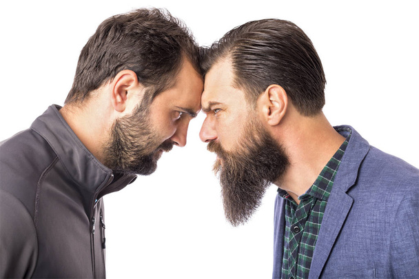 Two bearded angry men standing face to face isolated on white background - Photo, image