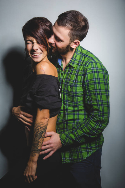 Beautiful couple hugging and laughing on the tein background. The concept of fun, love and happiness - Photo, Image