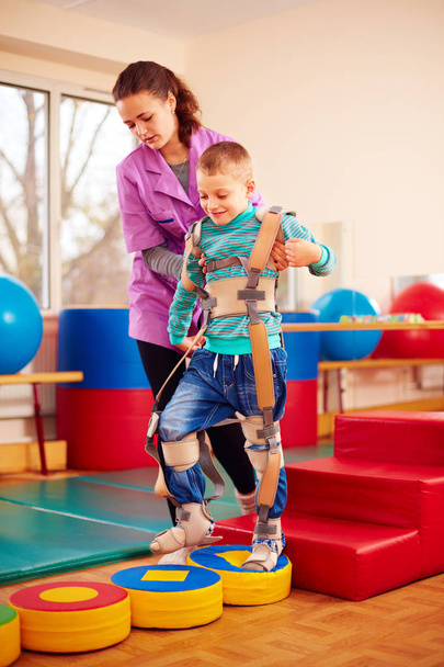cute kid having physical musculoskeletal therapy in rehabilitation center - Foto, Imagen