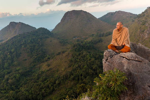 Buddhist master monk meditating in mountains - Photo, Image