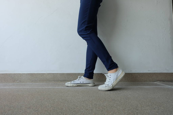 Fashion Young Woman in Blue Jeans and White Sneakers on the Streets  - Fotoğraf, Görsel