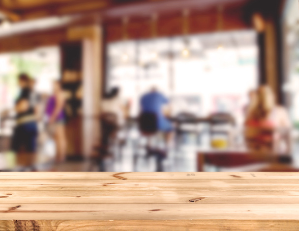 wood table counter with blurred people in coffee shop  - Photo, Image