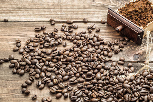 Box of ground coffee and roasted beans on wooden table - Foto, Imagen