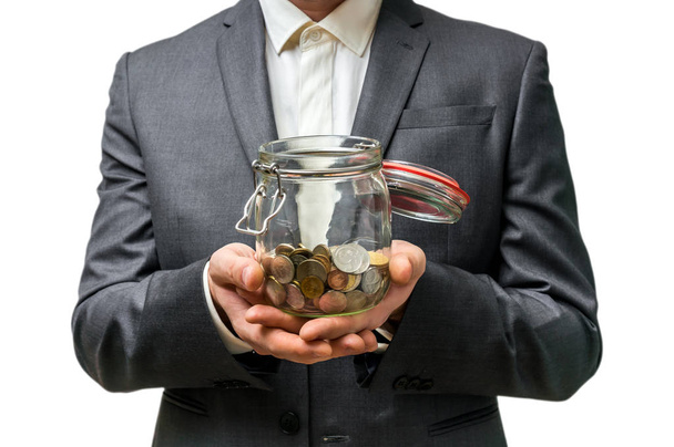 Man in black suit holding money jar with coins - Photo, Image