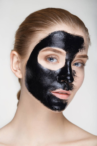 Beauty portrait woman skin care health black mask white background close up - Foto, afbeelding