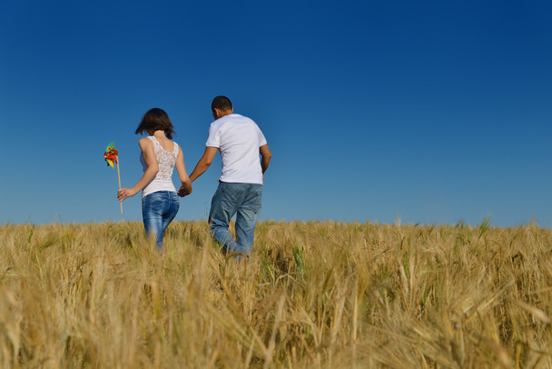happy couple in wheat field - Фото, изображение