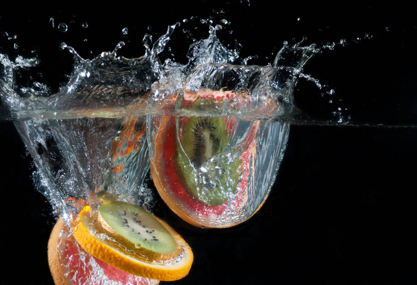 Tropical fruits fall underwater - Фото, изображение