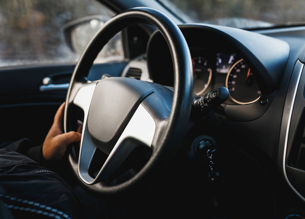 hand on steering wheel close up of a man driving a car - Fotó, kép
