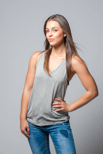 brunette femal on a grey background  - Фото, зображення