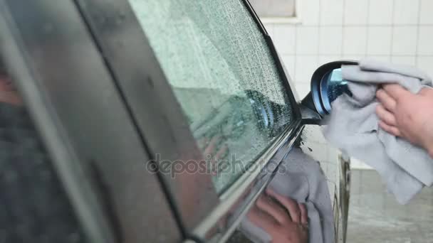 Hand wipe cleaning the car with microfiber cloth - Кадри, відео