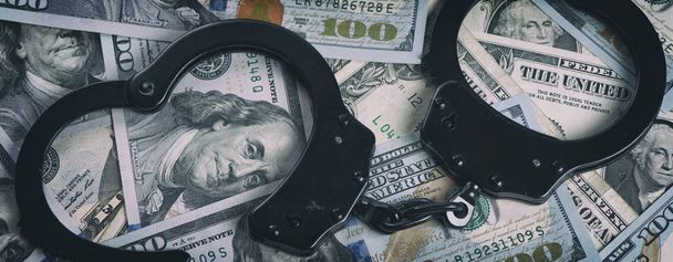 Handcuffs on money. US dollars - Valokuva, kuva
