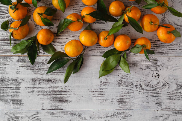 Ripe mandarins on a white wooden table - Fotoğraf, Görsel