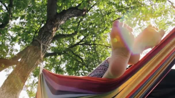 Low angle shot of girl feet in hammock - Footage, Video