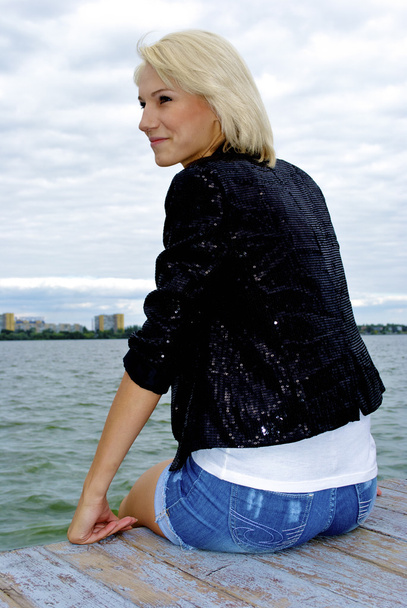 Nice blond caucasian model girl poses on the pier - Foto, Imagem