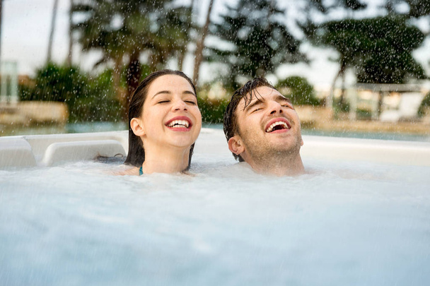 Young couple resting in jacuzzi - Fotoğraf, Görsel