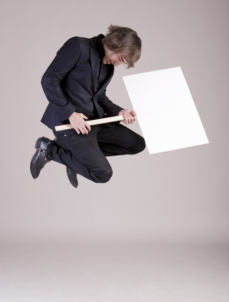 Young business man jumping with a space box - Photo, Image