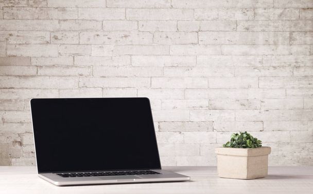 Business laptop with white brick wall - Photo, image