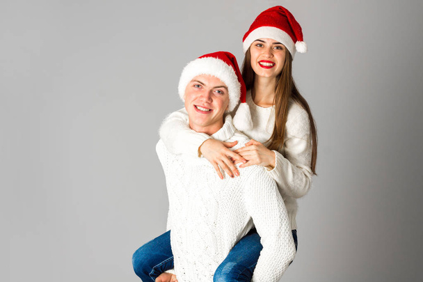 couple in love celebrates christmas in santa hat - Fotografie, Obrázek