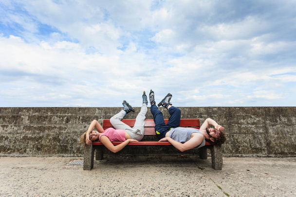Young tired people friends relaxing on bench. - Foto, afbeelding